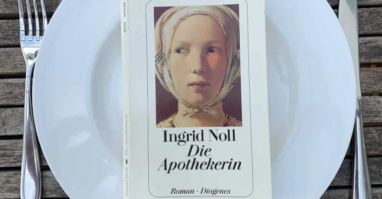 Der Roman „Die Apothekerin“ von Ingrid Noll liegt auf einem Teller, daneben das Messer und Gabel. Bereit zur Buchbesprechung?